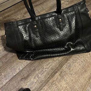 Beautiful black purse with some cutout pattern!